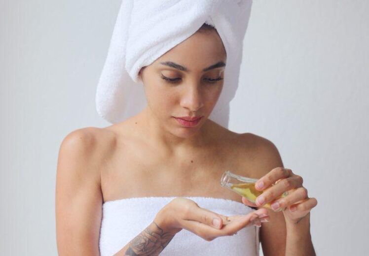 Girl rejuvenates skin with oil